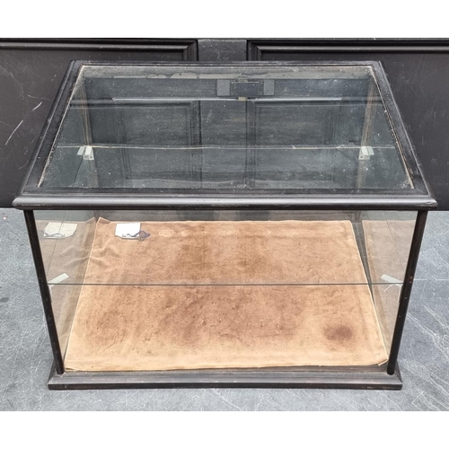 1063 - An ebonized table top display case, 39cm high x 58cm wide x 45.5cm deep.