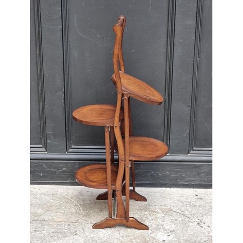 1070 - An Edwardian mahogany and line inlaid folding plate stand. 