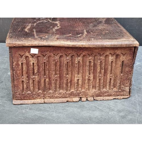 1071 - A late 17th century carved oak boarded bible box, 55cm wide. 