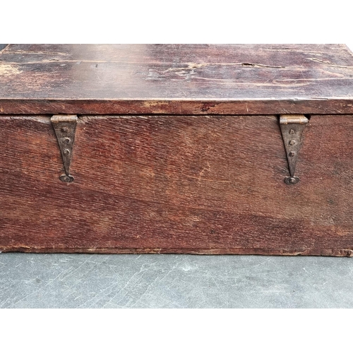 1071 - A late 17th century carved oak boarded bible box, 55cm wide. 