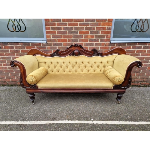 1074 - An early Victorian carved mahogany and button upholstered scroll arm settee, 201cm wide.... 