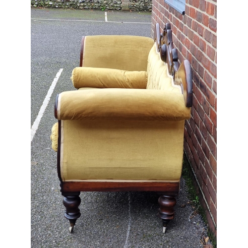 1074 - An early Victorian carved mahogany and button upholstered scroll arm settee, 201cm wide.... 