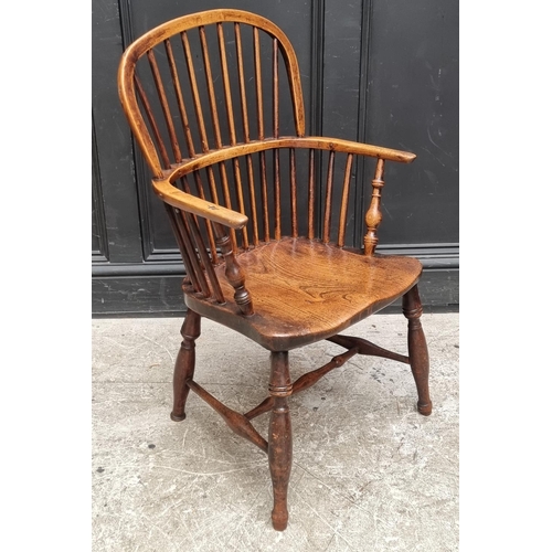 1077 - A 19th century ash and elm Windsor armchair, (legs reduced).