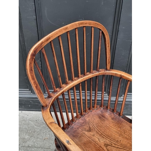 1077 - A 19th century ash and elm Windsor armchair, (legs reduced).