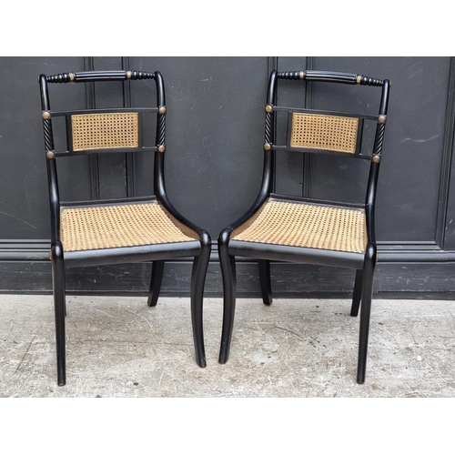 1081 - A pair of Regency ebonized and cane Trafalgar chairs. 