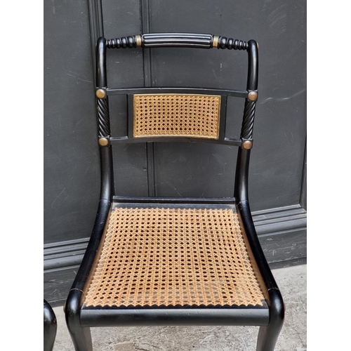 1081 - A pair of Regency ebonized and cane Trafalgar chairs. 