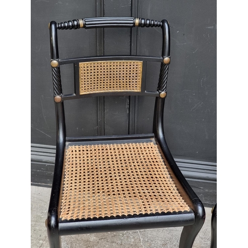 1081 - A pair of Regency ebonized and cane Trafalgar chairs. 