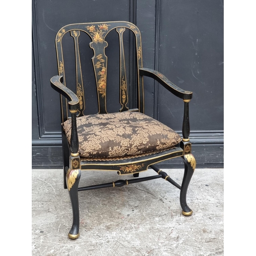 1085 - A 1920s black and gilt chinoiserie open arm low elbow chair.