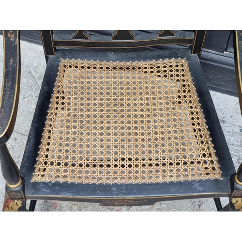 1085 - A 1920s black and gilt chinoiserie open arm low elbow chair.