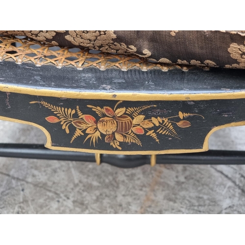 1085 - A 1920s black and gilt chinoiserie open arm low elbow chair.