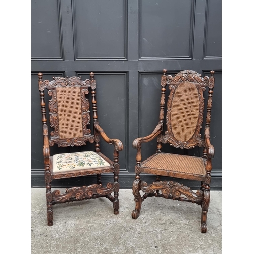 1088 - Two Carolean style cane backed open armchairs, one walnut, the other oak.