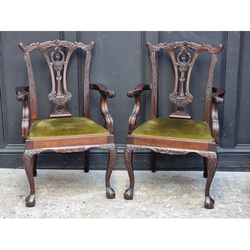 1089 - A pair of 18th century style carved mahogany elbow chairs.