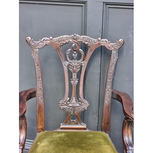 1089 - A pair of 18th century style carved mahogany elbow chairs.