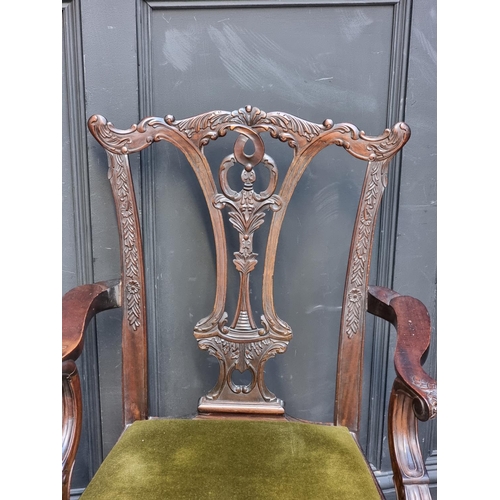 1089 - A pair of 18th century style carved mahogany elbow chairs.