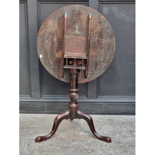 1091 - A George III mahogany circular tilt-top tripod table, with one-piece top and birdcage action, 71.5cm... 