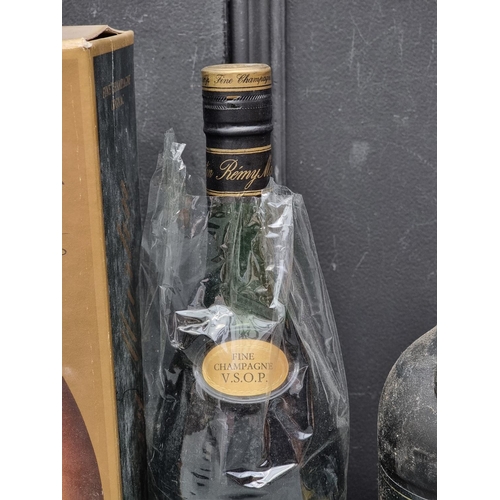 124 - Three bottles of Brandy, comprising: a 75cl Remy Martin VSOP Cognac, in card box; a 1 litre Remy Mar... 