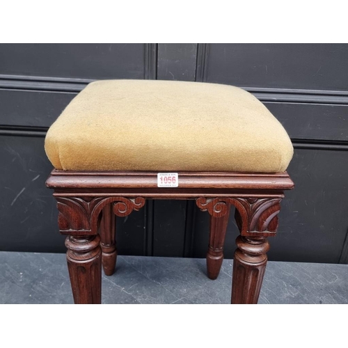 1056 - A Victorian carved mahogany stool.