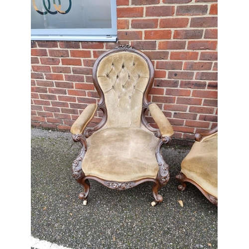 1090 - A pair of Victorian carved walnut and button upholstered occasional chairs.