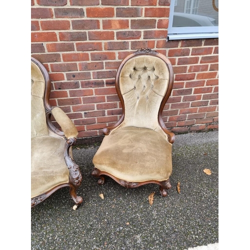 1090 - A pair of Victorian carved walnut and button upholstered occasional chairs.