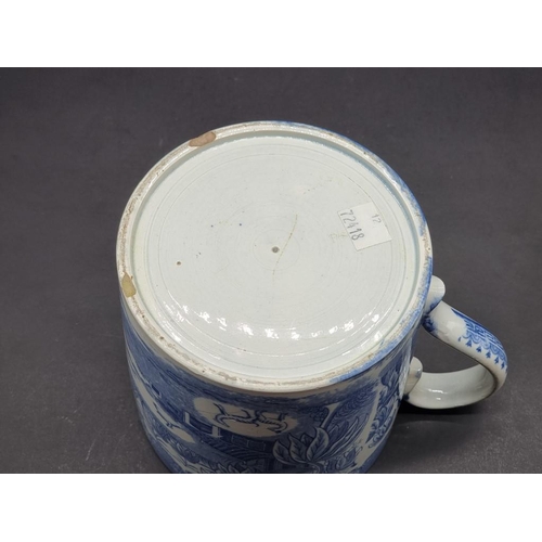 1480 - A 19th century English blue and white pottery tankard, printed with a stylised landscape, 12.5cm hig... 