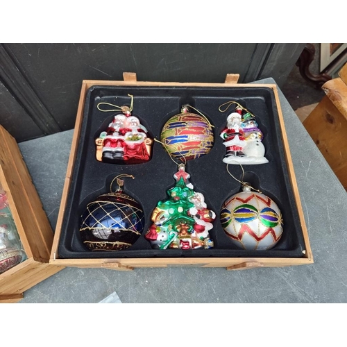 1506 - A collection of sixteen Thomas Pacconi Christmas tree baubles, in two pine crates.... 