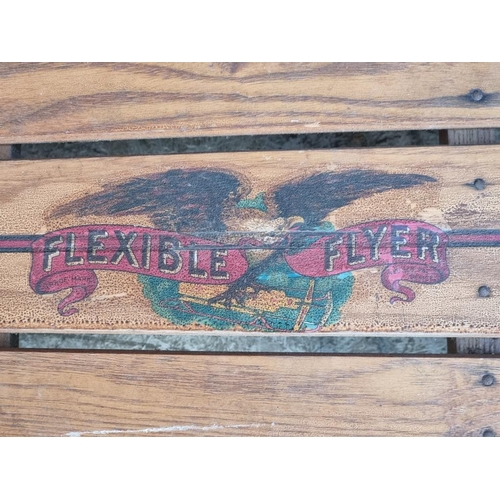 1512 - A vintage American 'Flexible Flyer' sledge, 121cm long.