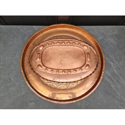 1545 - A large Eastern copper tray, 66.5cm diameter; together with another oval example, stamped 'J Picard ... 