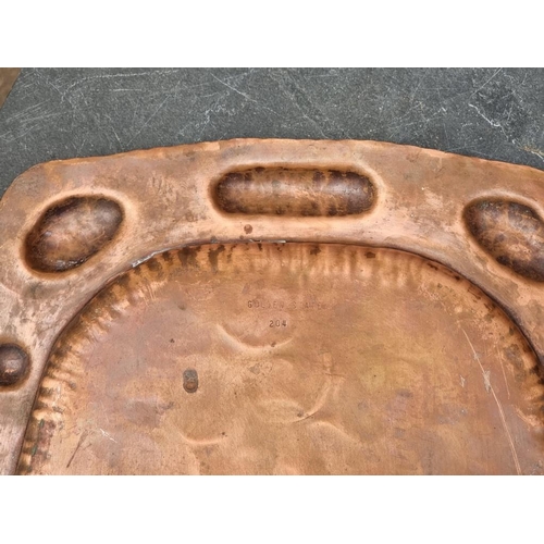 1545 - A large Eastern copper tray, 66.5cm diameter; together with another oval example, stamped 'J Picard ... 