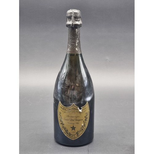 67 - A 70cl bottle of Moet et Chandon Dom Perignon 1985 Vintage Champagne, (small tear to label).... 