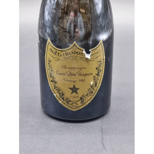 67 - A 70cl bottle of Moet et Chandon Dom Perignon 1985 Vintage Champagne, (small tear to label).... 