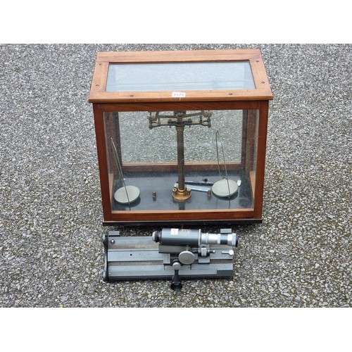 1522 - A cased set of laboratory balance scale, 42 x 43cm; together with a C Baker table top microscope. (2... 