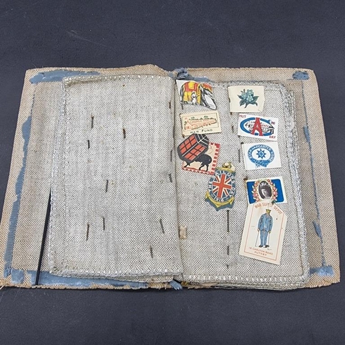 249 - WORLD WAR I CHARITY PINS: cloth album containing circa 100 paper, fabric and metallic charity p... 