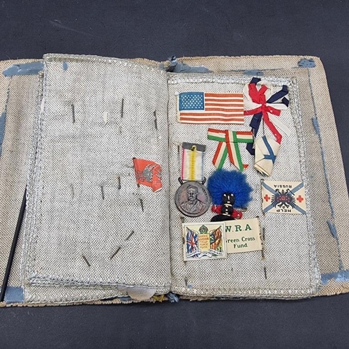 249 - WORLD WAR I CHARITY PINS: cloth album containing circa 100 paper, fabric and metallic charity p... 