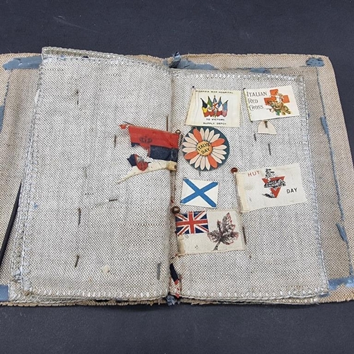 249 - WORLD WAR I CHARITY PINS: cloth album containing circa 100 paper, fabric and metallic charity p... 