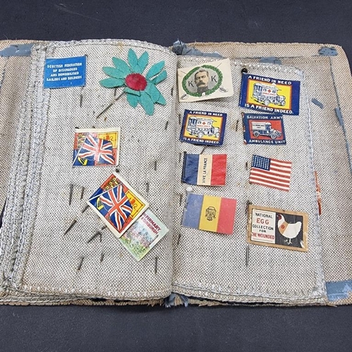 249 - WORLD WAR I CHARITY PINS: cloth album containing circa 100 paper, fabric and metallic charity p... 