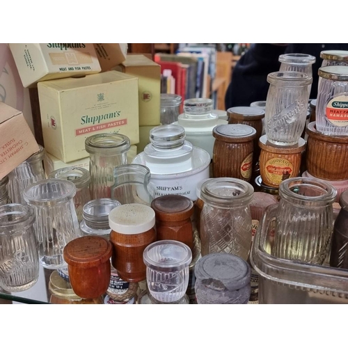 498 - SHIPPAM'S OF CHICHESTER: a shelf of Shippam's pots and packaging, including manufacturer's dumm... 