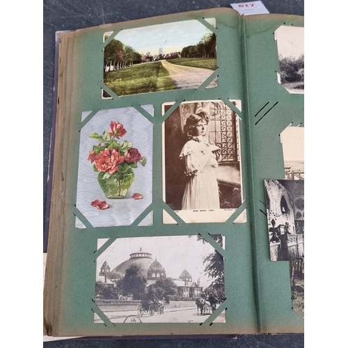 617 - POSTCARDS: a vintage album of cards, grey cloth covers with floral design to upper board. (Albu... 