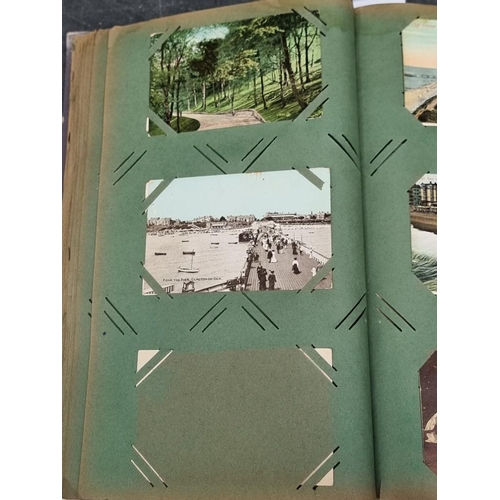 617 - POSTCARDS: a vintage album of cards, grey cloth covers with floral design to upper board. (Albu... 