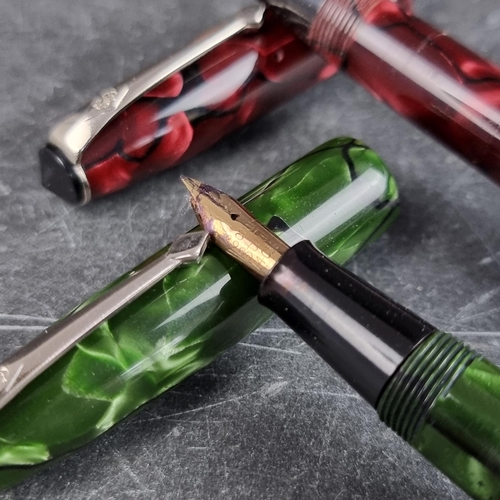 13 - Two circa 1952-63 Conway Stewart 15 marbled fountain pens, comprising plum and green examples, 12.7c... 
