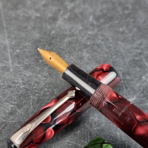 13 - Two circa 1952-63 Conway Stewart 15 marbled fountain pens, comprising plum and green examples, 12.7c... 