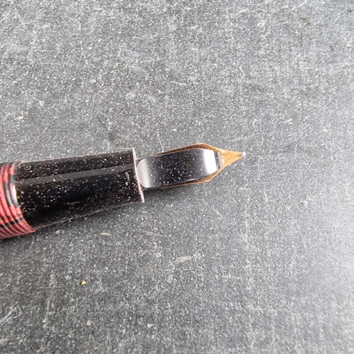 13 - Two circa 1952-63 Conway Stewart 15 marbled fountain pens, comprising plum and green examples, 12.7c... 