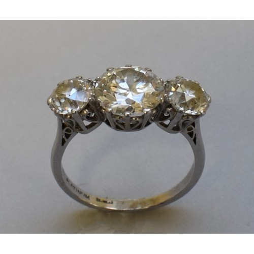 291 - An old European cut diamond and platinum three stone ring, the central stone 2.6ct, colour J/K, clar...