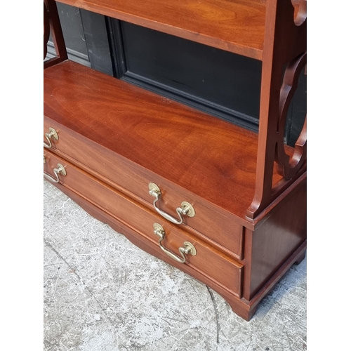 1012 - A reproduction mahogany hanging open bookshelf, with two apron drawers, 112.5cm high x 68.5cm wide.... 