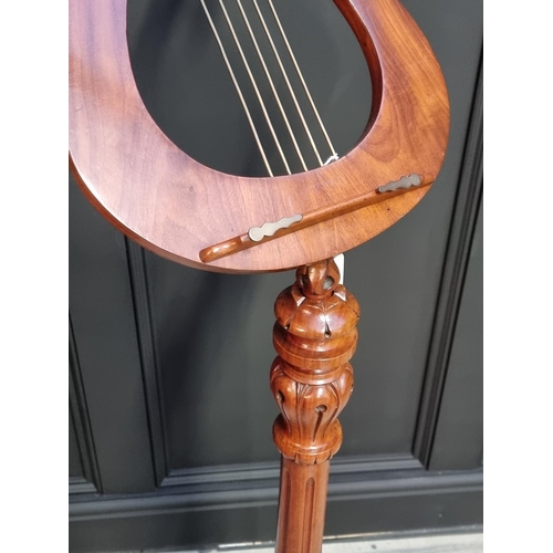 1024 - A 19th century carved mahogany adjustable music stand.