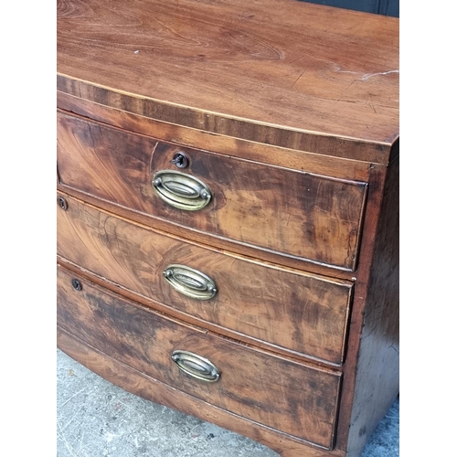 1031 - A small early 19th century bowfront chest of drawers, 96cm wide.