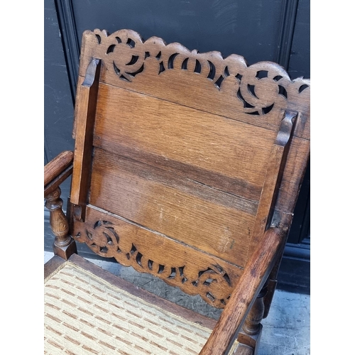 1037 - A pair of unusual oak monk's bench style chairs, 52.5cm wide.