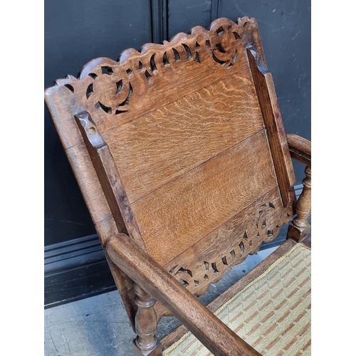 1037 - A pair of unusual oak monk's bench style chairs, 52.5cm wide.