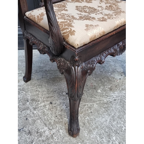 1051 - An antique Chippendale style carved mahogany elbow chair.