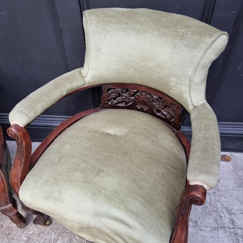 1054 - A pair of circa 1900 walnut and upholstered tub chairs.