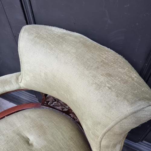 1054 - A pair of circa 1900 walnut and upholstered tub chairs.